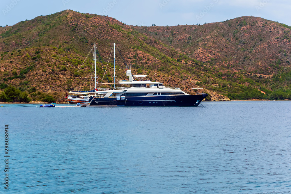 Luxury yachts on the background of rocks