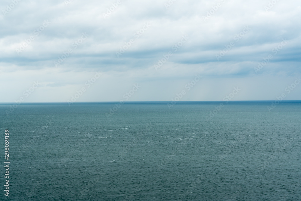 Fototapeta premium meditative ocean and sky landscape with expressive clouds