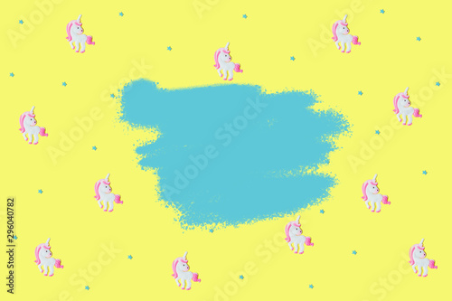Blue stars and pink unicorns on yellow backdrop.