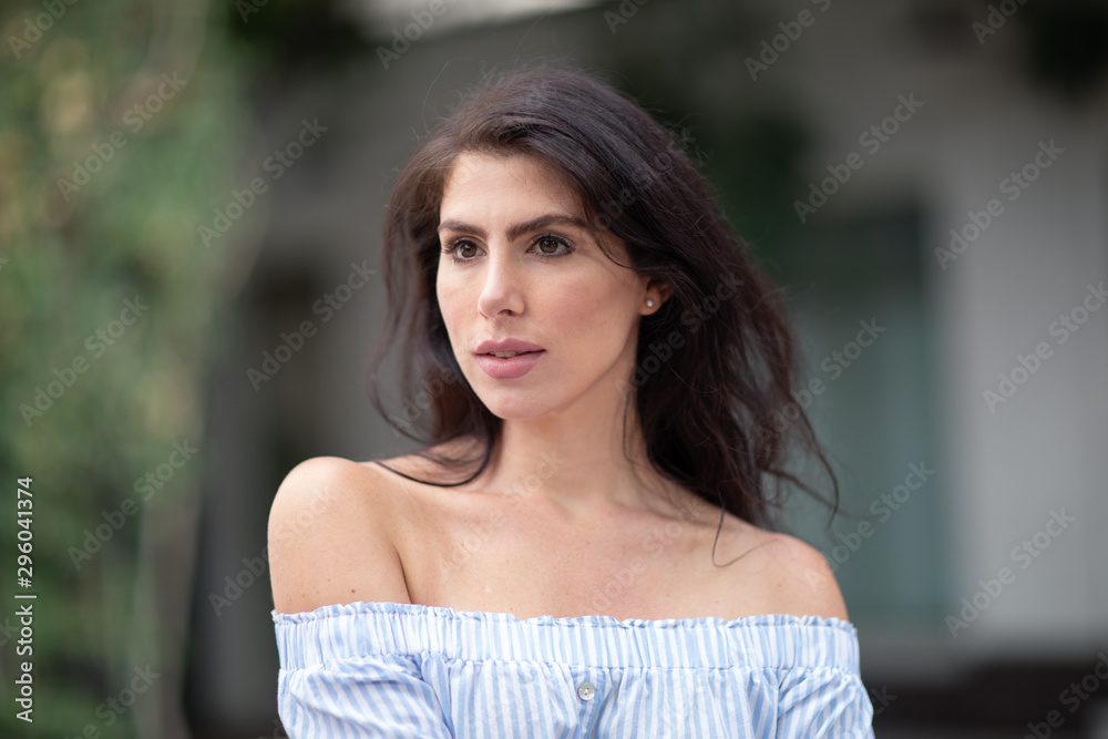 A portrait of a lovely romantic young woman outdoors, inspiringly looking forward