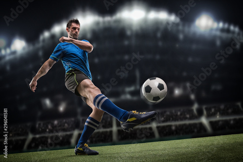 Soccer player in action on night stadium background © romanolebedev
