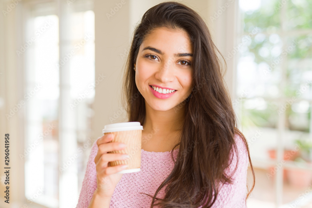 Beautiful young girl drinking a cup of coffee at home and smiling Beautiful young girl drinking a cup of coffee at home and smiling