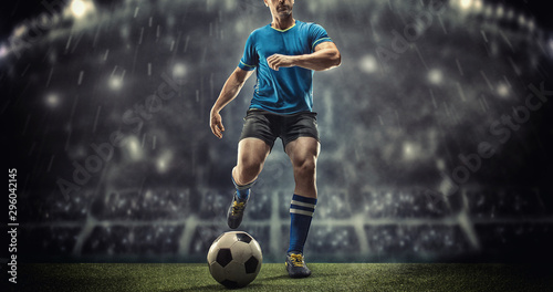 Soccer player in action on a dark background © romanolebedev