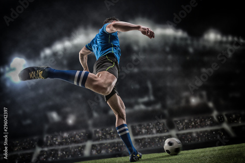 Tablou canvas Football player with ball on field of stadium