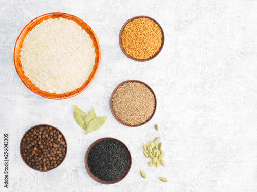 Spices set and rice on white concrete background with copy space. Modern apothecary, naturopathy and ayurveda concept.