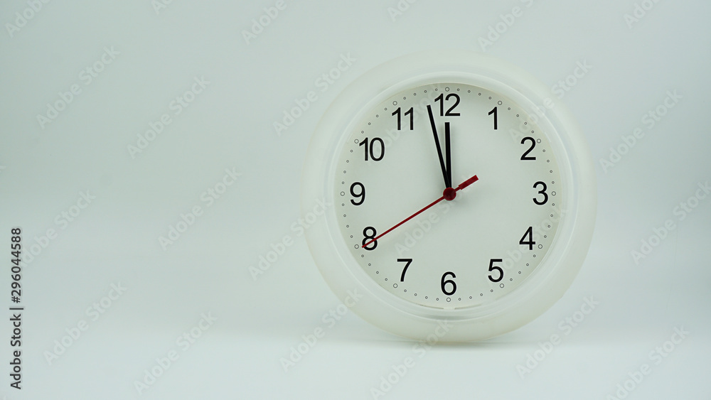 Clock beginning of time 11.57 am or pm, on white background, Copy space for your text, Time concept. Clock beginning of time 11.57 am or pm, on white background, Copy space for your text, Time concept.