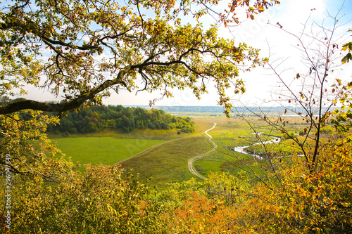 Autumn field from the hill. Road in the nature. Beautiful landscape with a river.