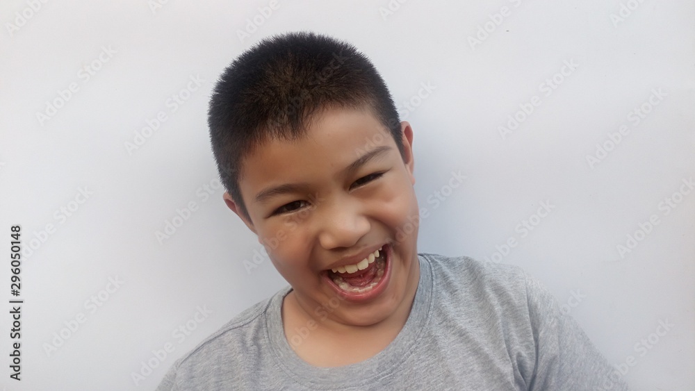 The boy in gray shirt is smiling and has a happy face ... white background The boy in gray shirt is smiling and has a happy face ... white background