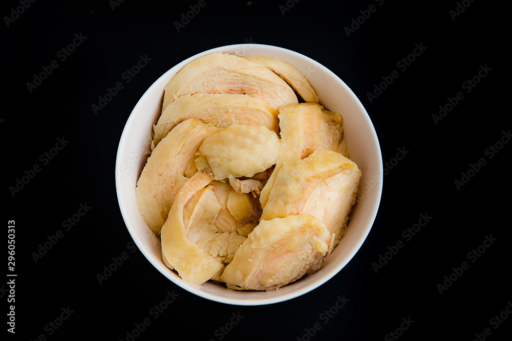 Thinly sliced ​​boiled chicken on black background
