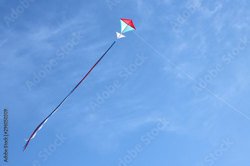 Colorful kite flying and blue sky as background