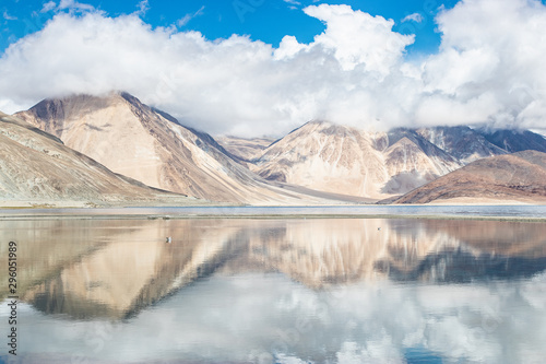 Reflections of high mountain with white cloud and blue sky on the Pagong lake, Leh Ladakh, India.