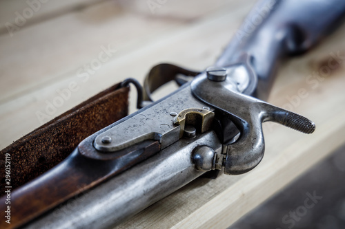 Antique flintlock gun lies on a wooden table.