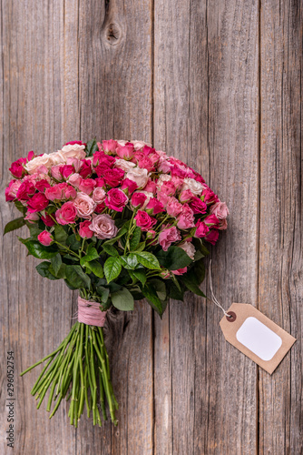 A bouquet of roses on a wooden background. © Tanya Rozhnovskaya