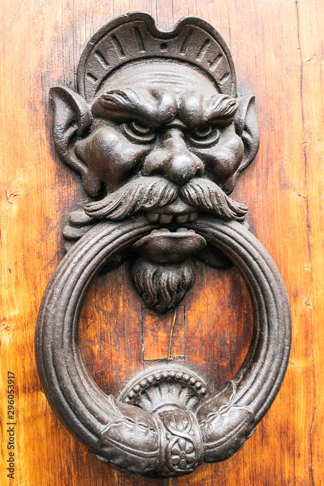 Antique knocker in the shape of an angry gnome face Antique knocker in the shape of an angry gnome face