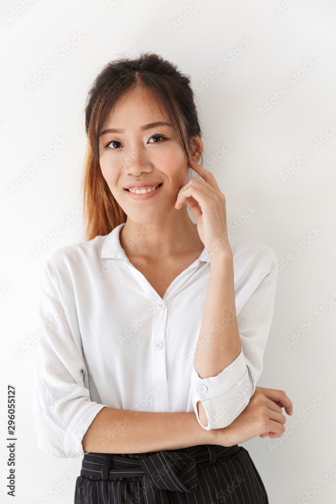 Attractive smiling asian woman standing isolated Attractive smiling asian woman standing isolated