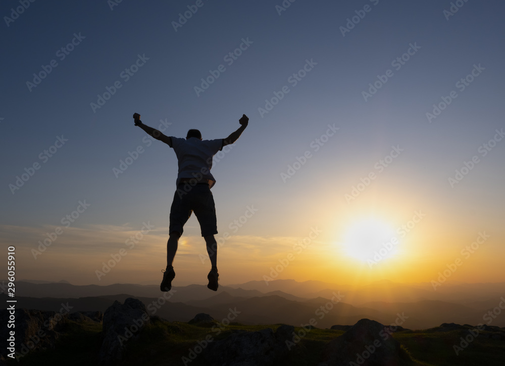 man celebrating success at sunset man celebrating success at sunset