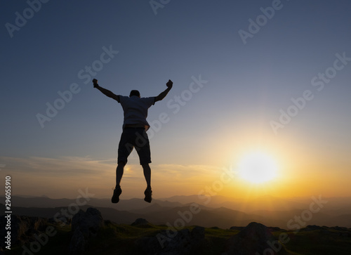 man celebrating success at sunset