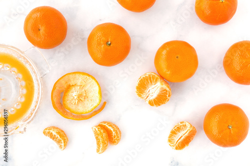 Vászonkép Clementines, Clementine Segments and Citrus Juicer on Marble