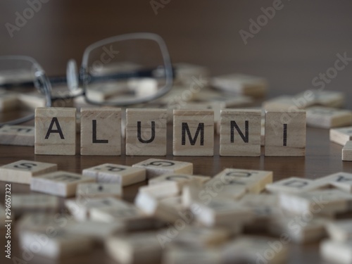 The concept of Alumni represented by wooden letter tiles photo