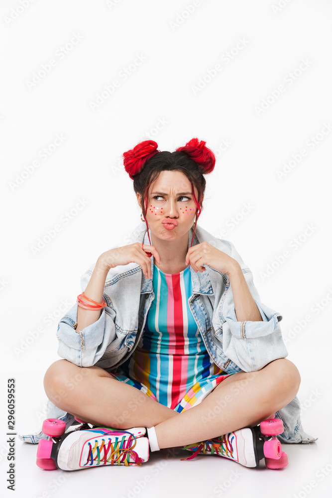Image of displeased cute woman grimacing while sitting on floor Image of displeased cute woman grimacing while sitting on floor