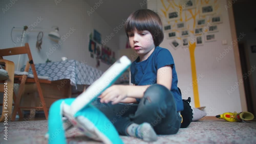 boy is playing with soft toy in the room boy is playing with soft toy in the room