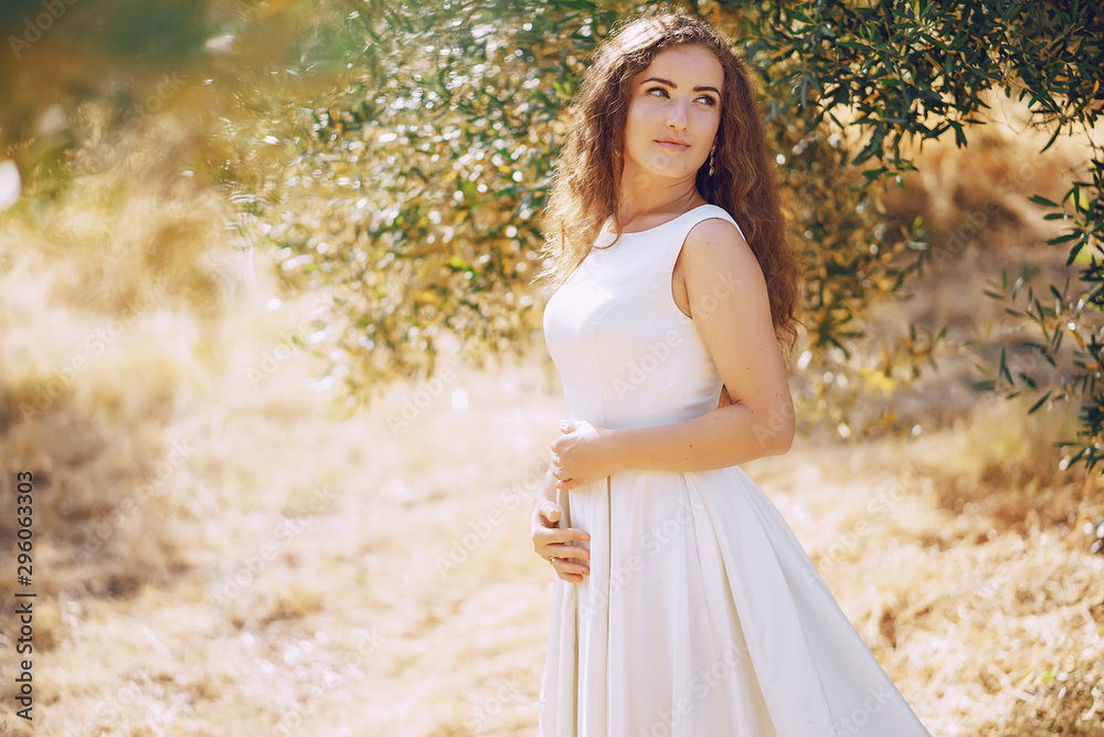 Beautiful long-haired bride in a magnificent white dress walking in nature Beautiful long-haired bride in a magnificent white dress walking in nature