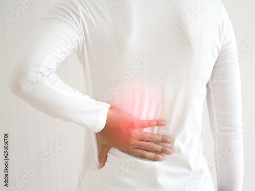 Tableau sur toile herniated disc,spondylosis and scoliosis in asian woman and she touching her back cause of strains or disc injury and spinal stenosis use for health care concept