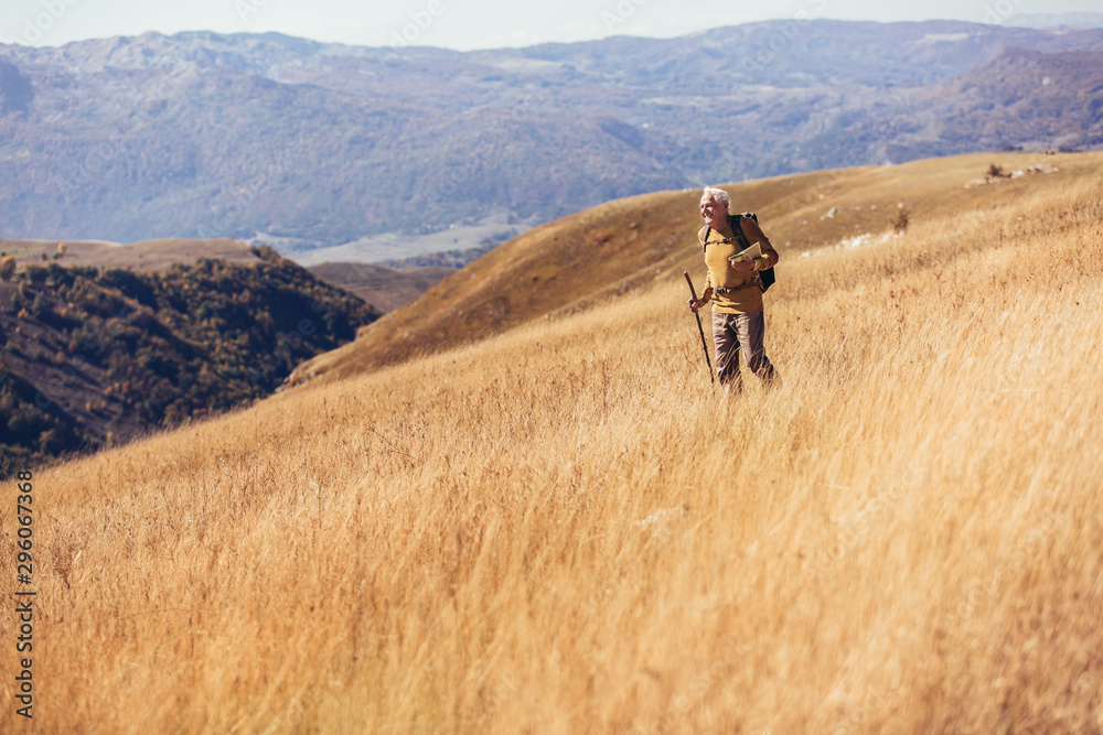 Senior man on hike through beautiful countryside in autumn. Senior man on hike through beautiful countryside in autumn.