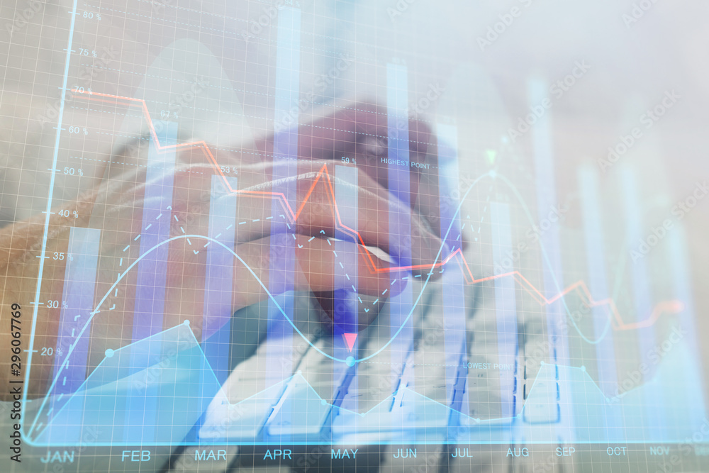 Double exposure of graph with man typing on computer in office on background. Concept of hard work. Closeup. Double exposure of graph with man typing on computer in office on background. Concept of hard work. Closeup.