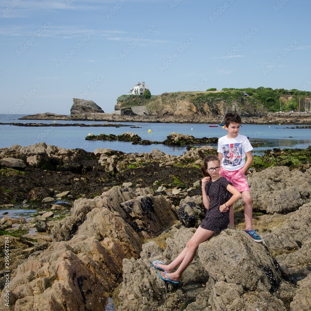 des enfants sur une plage rocheuse en Bretagne. Des enfants en vacances à la mer. Les vacances en Bretagne