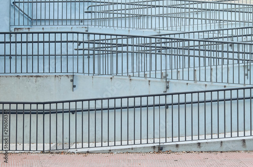 ramp in a street with a frey handrail and wall in blue ice color