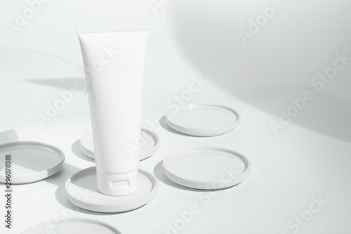 fresh beauty spa medical skincare and cosmetic lotion cream facial tube bottle packaging product on white decor background with summer season sun light