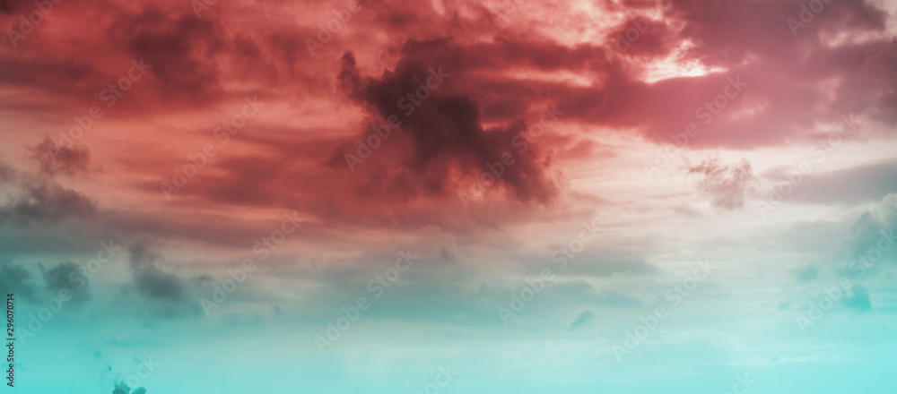 Red blue cloudy sky at sunset, toned photo