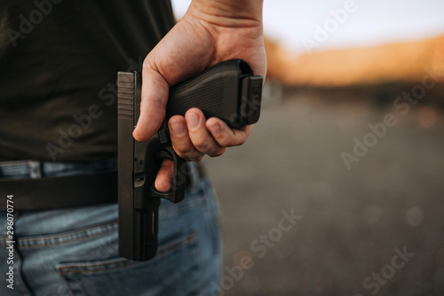 Man with a gun, close-up, copy space.