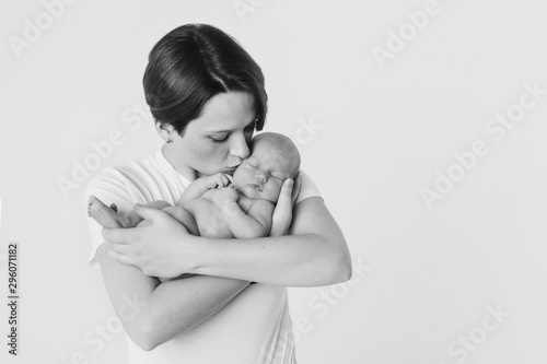 photo in black and white: the mother holds her son in her arms. Family portrait: a woman with a child. Health care concept: healthy family