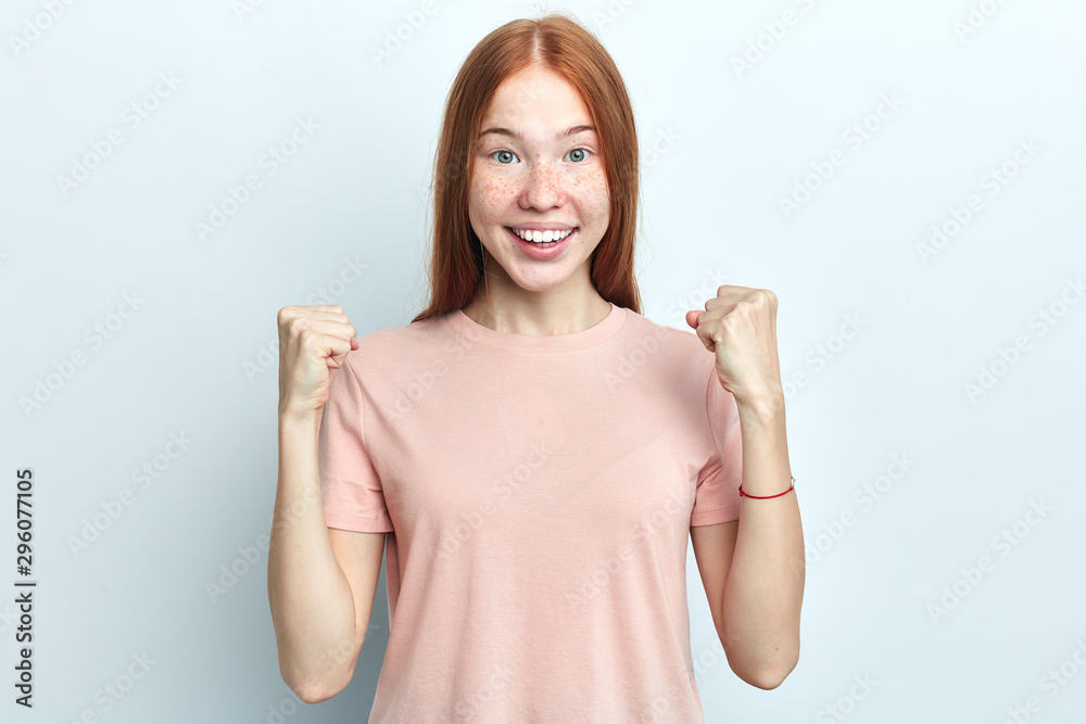 excited student with overjoyed expression, rejoices her success, keeps fists raised, isolated over white background. People, victory and celebration. I've done it. close up portrait excited student with overjoyed expression, rejoices her success, keeps fists raised, isolated over white background. People, victory and celebration. I've done it. close up portrait