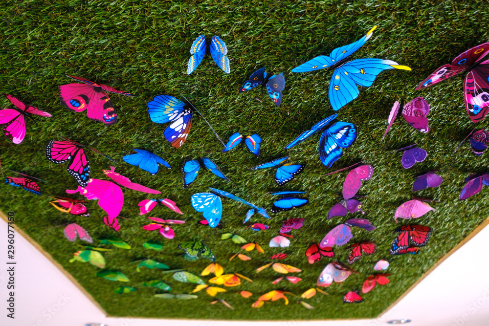Fake butterflies on astroturf Stock Photo