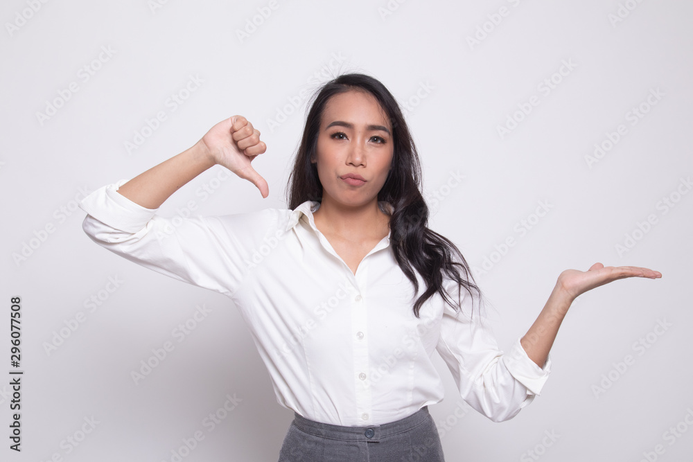 Young Asian woman show palm hand and thumbs down. Young Asian woman show palm hand and thumbs down.