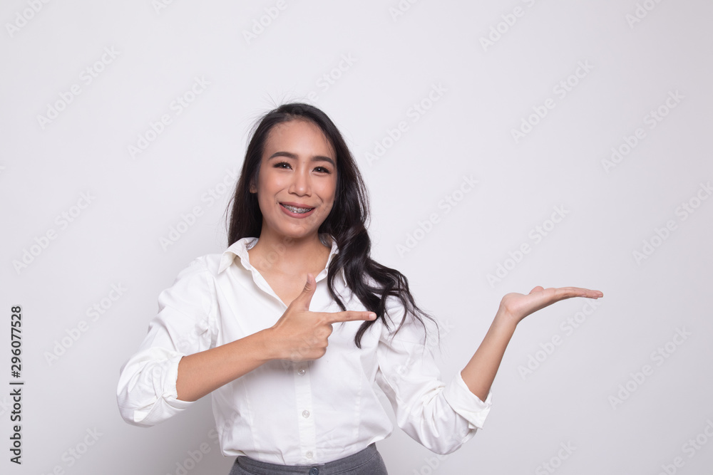Beautiful young Asian woman point to palm hand. Beautiful young Asian woman point to palm hand.