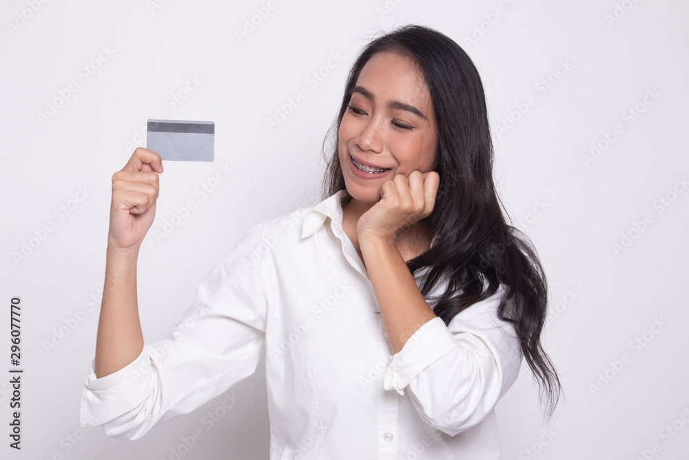 Happy young Asian woman with a blank card. Happy young Asian woman with a blank card.