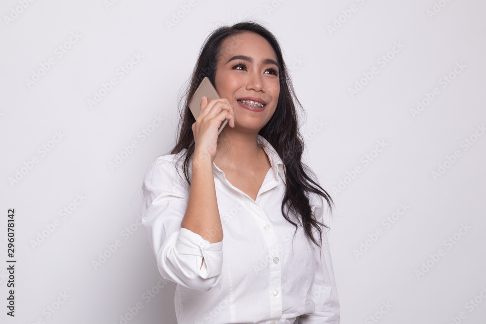Young Asian woman talking with mobile phone. Young Asian woman talking with mobile phone.