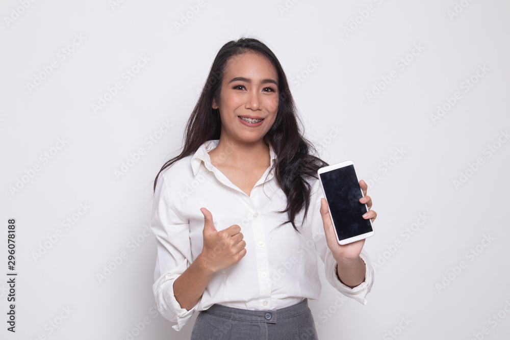 Young Asian woman show thumb up with mobile phone. Young Asian woman show thumb up with mobile phone.