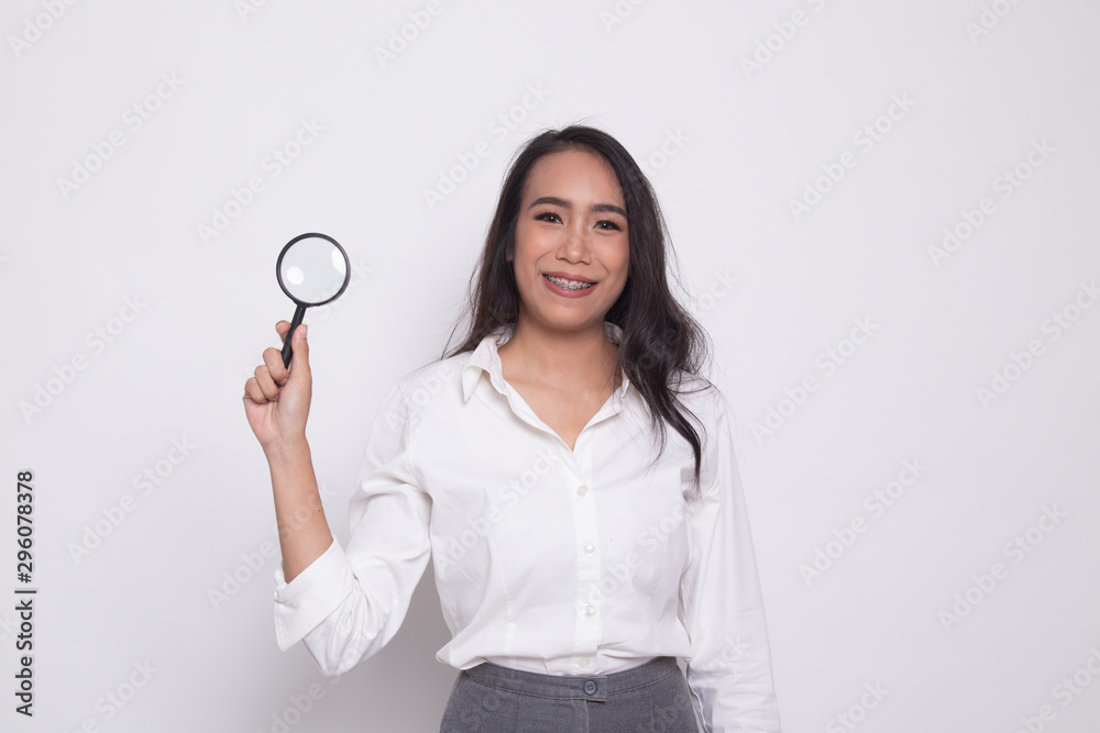 Young Asian woman with a magnifying glass. Young Asian woman with a magnifying glass.