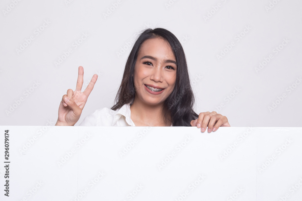 Young Asian woman show victory sign with blank sign. Young Asian woman show victory sign with blank sign.