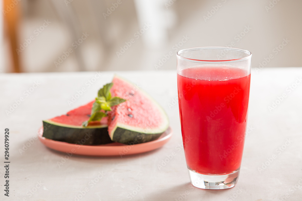 Watermelon juice, watermelon slices and mint leaves.