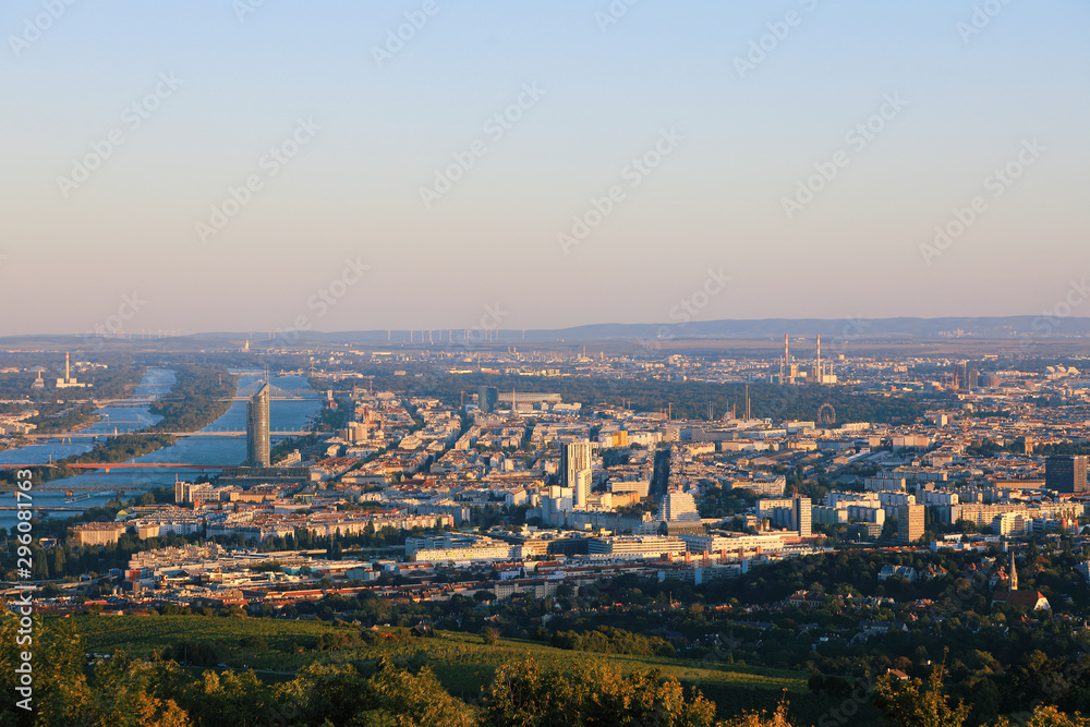 Vienna, Austria - 21 September 2019: Beautiful view of the evening skyline of Vienna and Danube River with green trees of Doebling district, Austria. Travel photo of the landmark