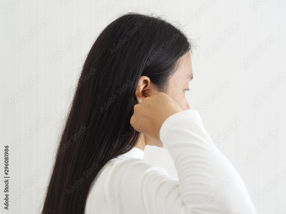 itchy ear in asian woman causes of otitis externa and hearing aid use and psoriasis use for health care concept. itchy ear in asian woman causes of otitis externa and hearing aid use and psoriasis use for health care concept.