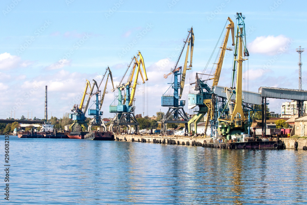 cargo port with tower cranes on a river