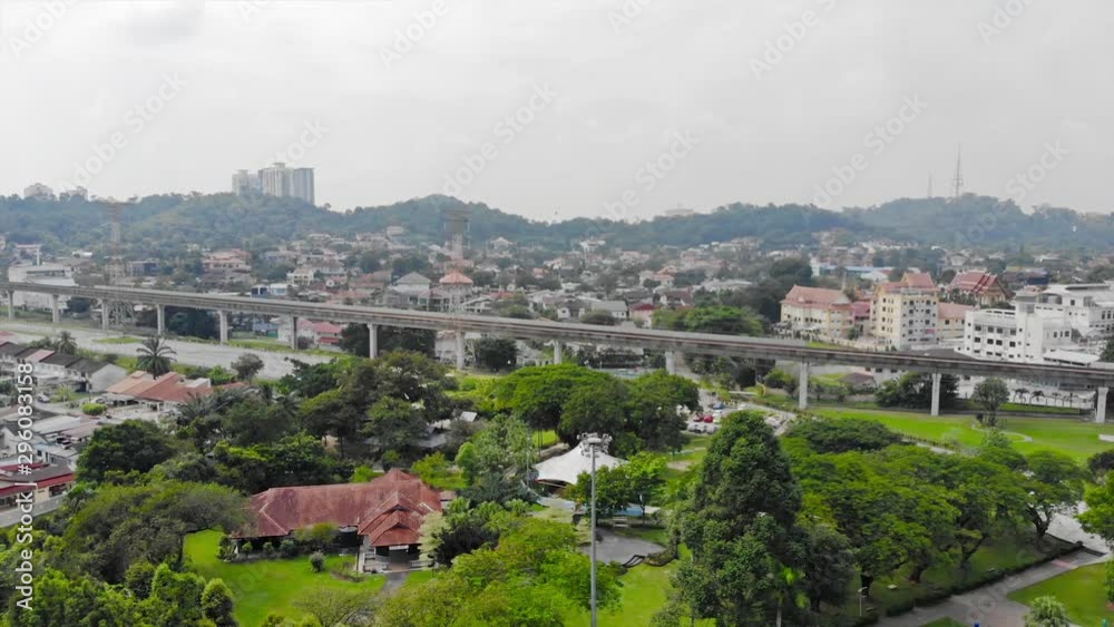 Top Aerial View Of Green Park Full With Tree Near Of Toll Road In Taman Jaya Park - Dolly Right To Left Top Aerial View Of Green Park Full With Tree Near Of Toll Road In Taman Jaya Park - Dolly Right To Left