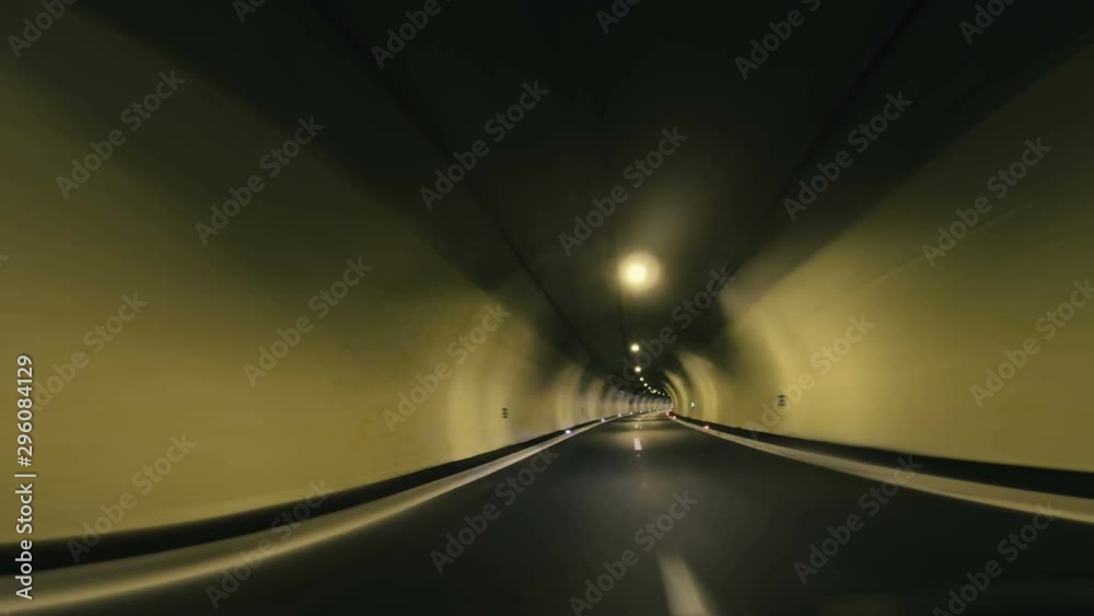 Motorcyclist driving through highway road tunnel , pov